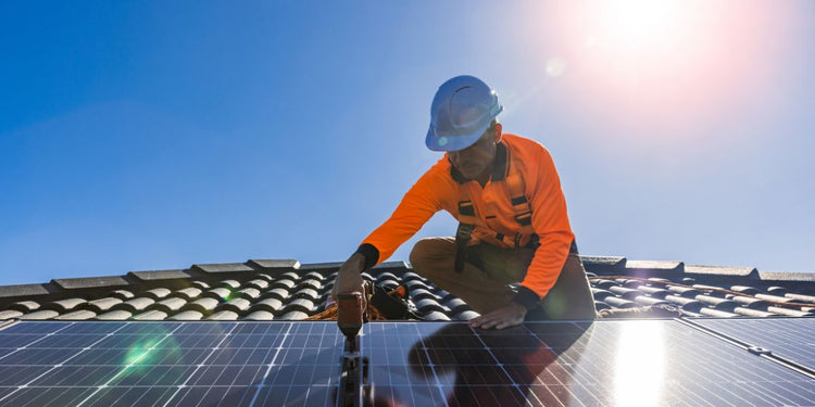 Renewable energy installing solar panels on a roof .